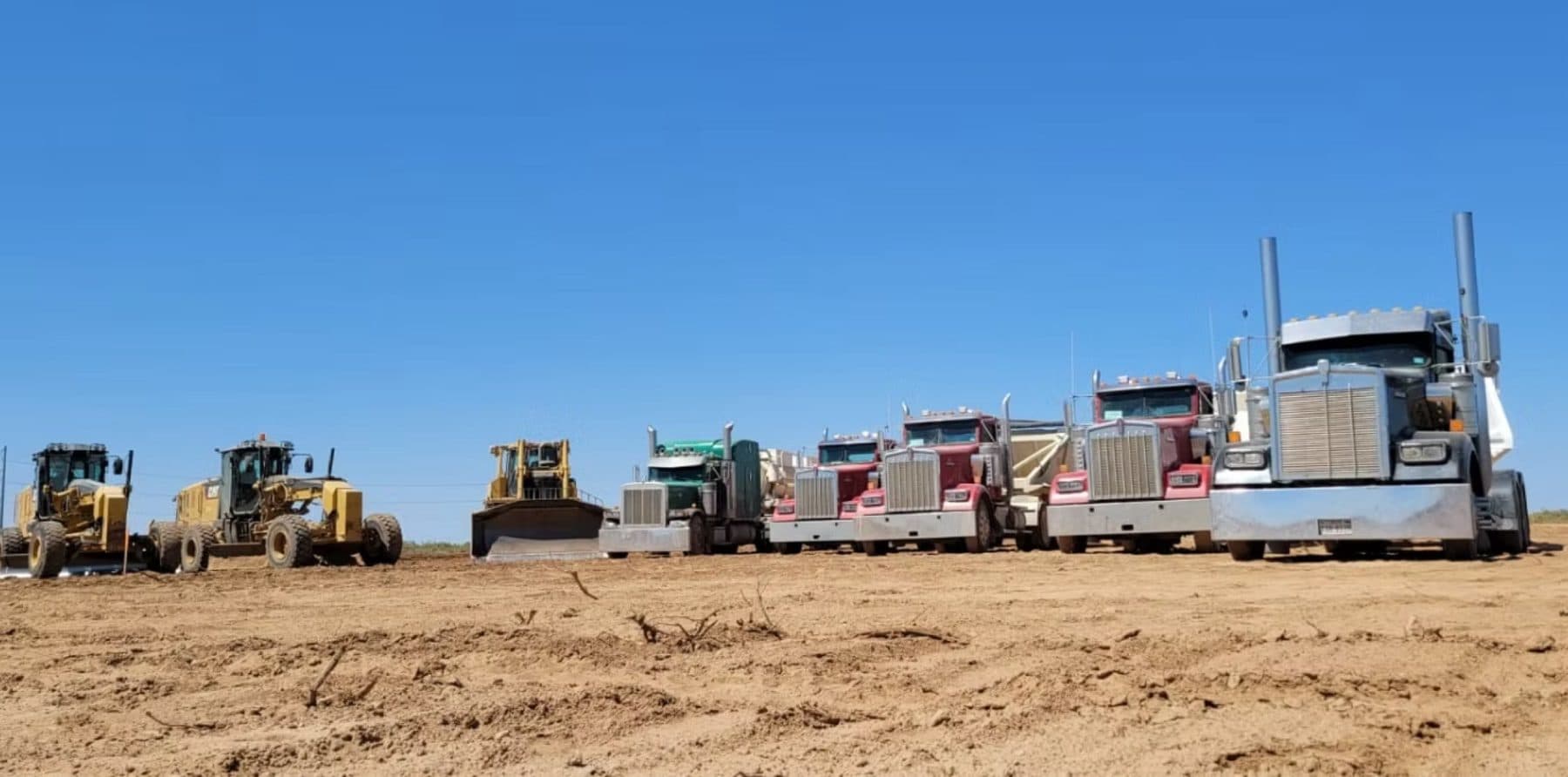 Lobos fleet — trucks and heavy equipment staged on location